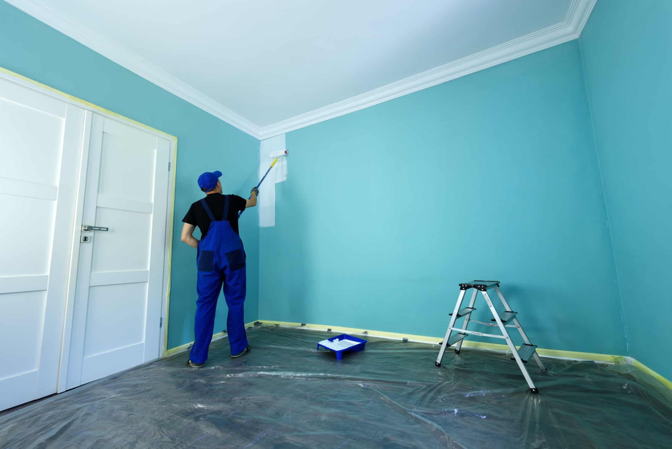 A man painting the wall with paint rollers- Fort Collins, CO painting services