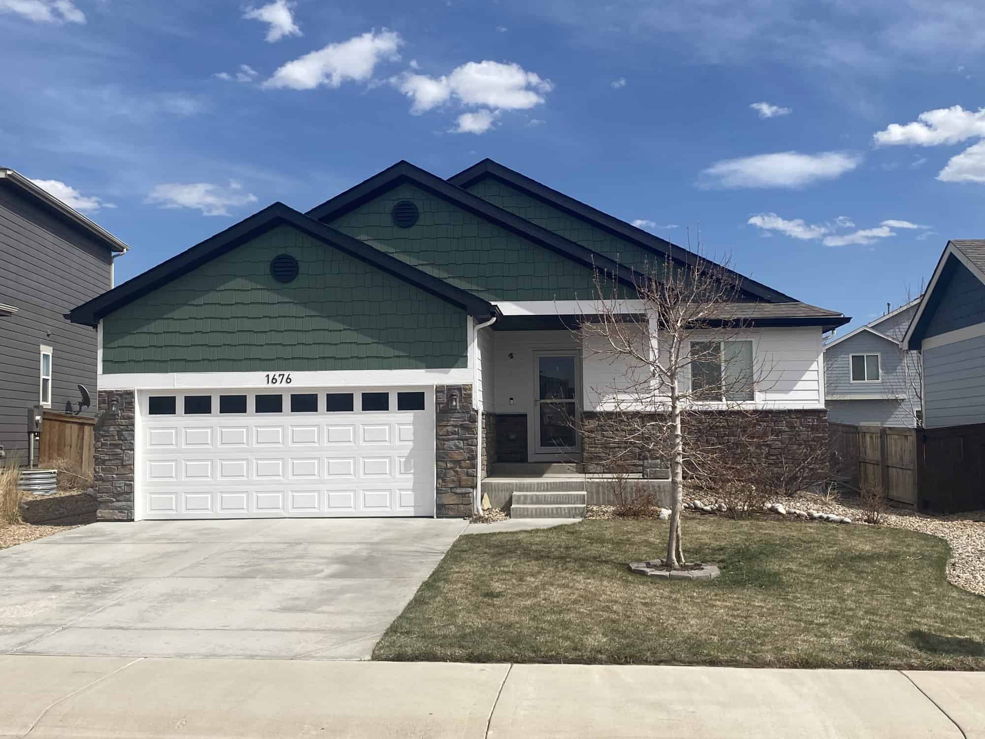 Newly Painted House Exterior with Garage, Lawn and Driveway- painting services in Arvada, CO