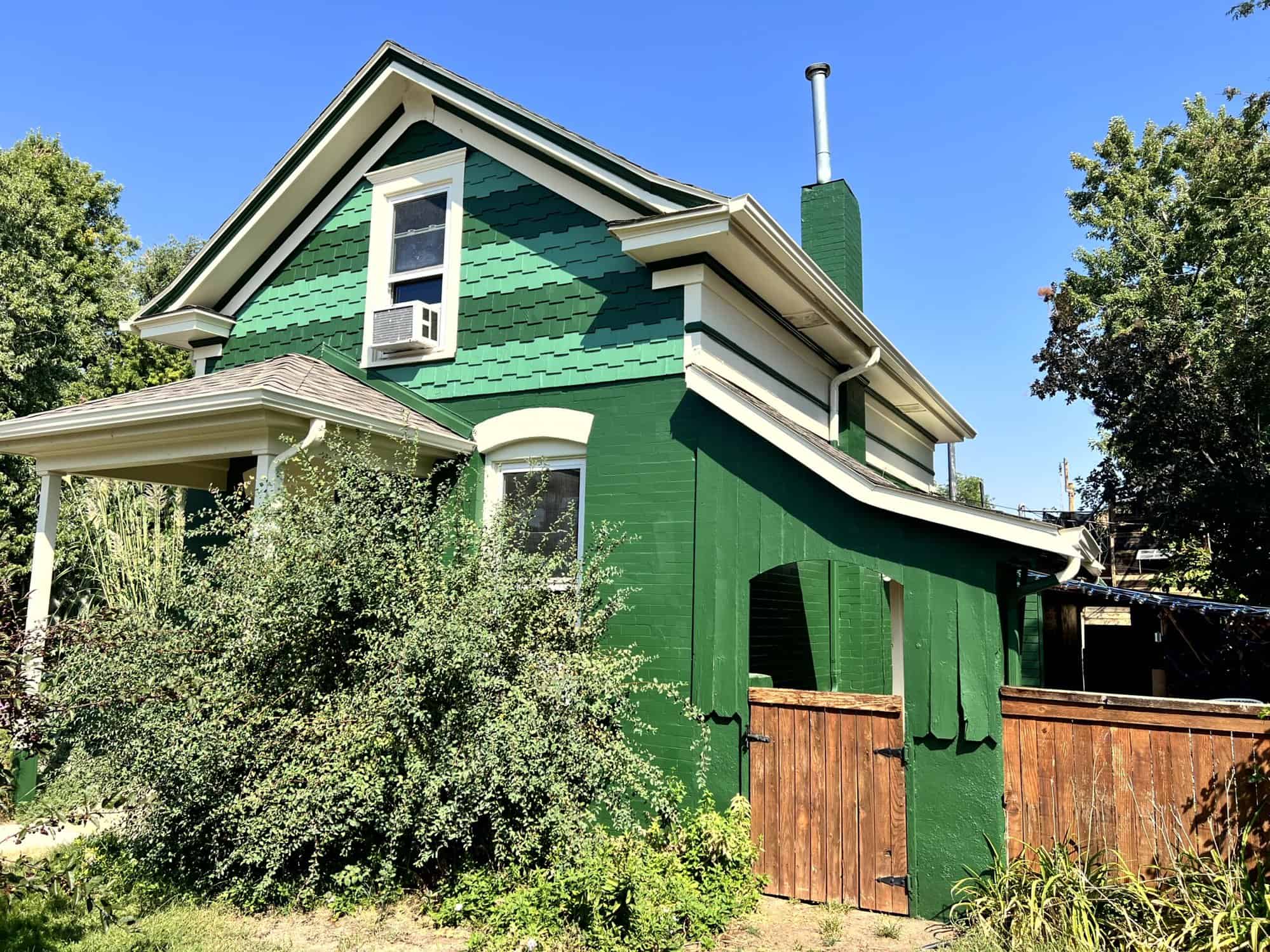 Green Painted House Exterior with Trees surrounding it- painting services in Longmont, CO