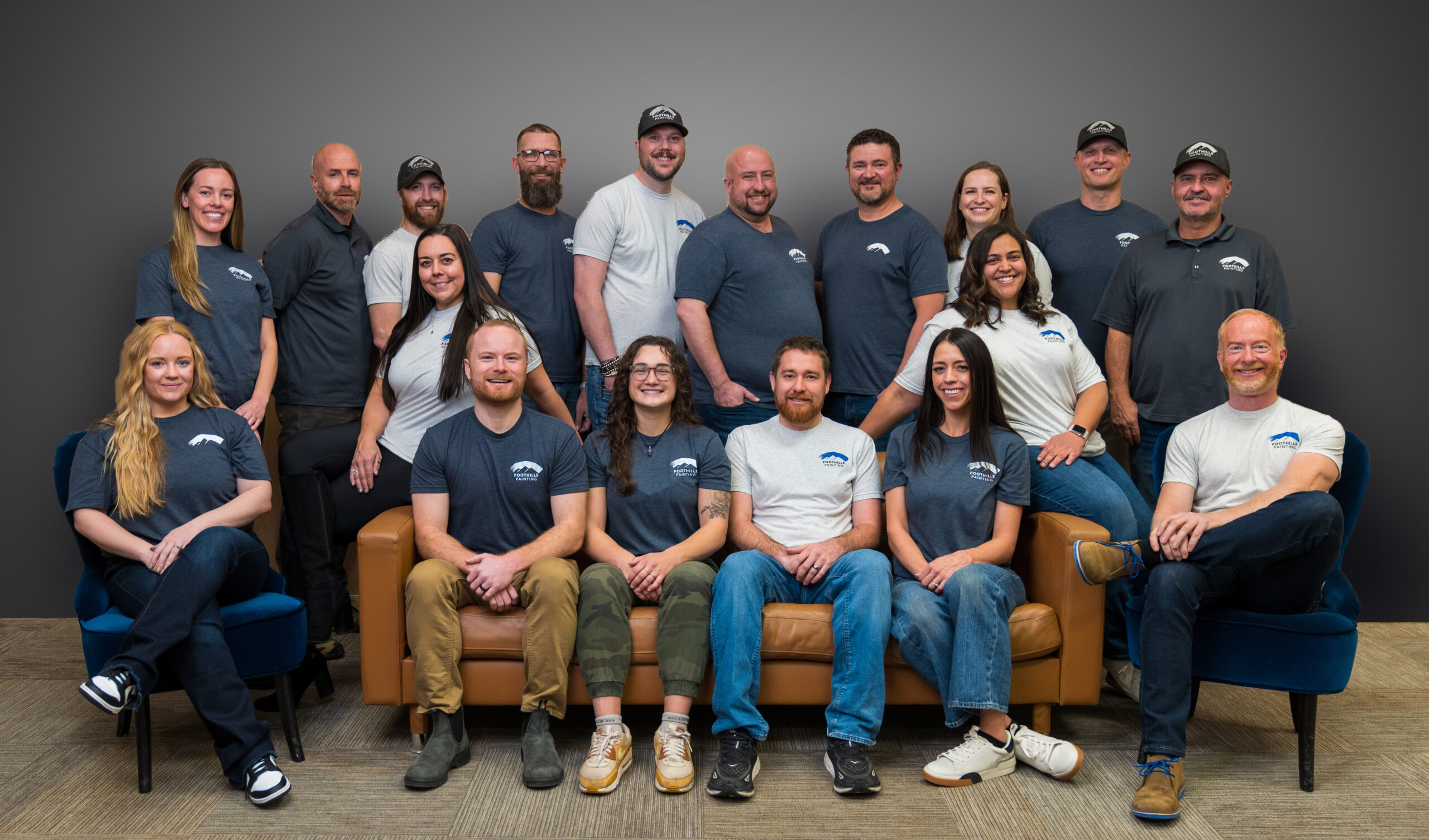 The side view of a large gray new constructed house with a landscaped yard a three car garage and driveway- Fort Collins, CO painting company
