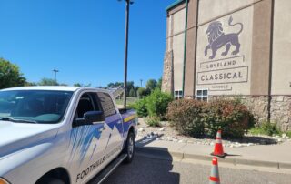 Foothills Painting truck at Loveland Classical Schools for commercial exterior project Foothills Painting truck parked outside Loveland Classical Schools, ready for a commercial exterior painting project.