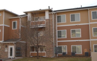 Apartment Complex Exterior Commercial Painting Services Expert commercial exterior painting for a large multi story apartment complex featuring tan, brown, and white colors.