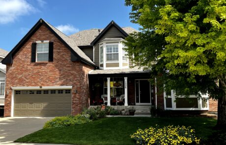 Professional Exterior House Painting Services for Brick and Siding Homes A beautiful two story brick and siding house with dark brown and tan paint, showcasing professional exterior painting.
