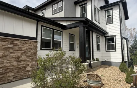 Full Exterior House Painting Service for a Contemporary Home A contemporary house showcasing a complete exterior paint job with white, gray, and black details.