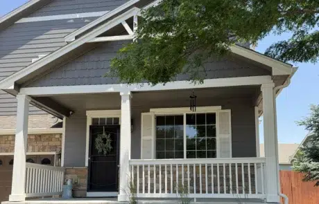 Beautiful Gray House Exterior with White Trim and Porch A residential home with freshly painted gray siding, crisp white trim, and a welcoming front porch.