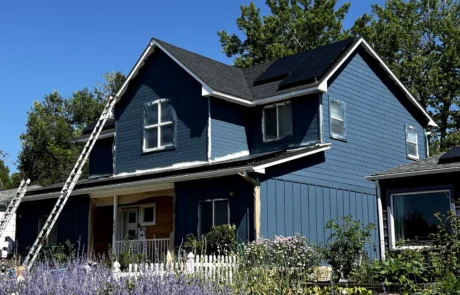 Navy Blue Two-Story Residential Home Navy blue and light blue fiber cement siding two-story home with white-trimmed windows, dark roof, and front porch